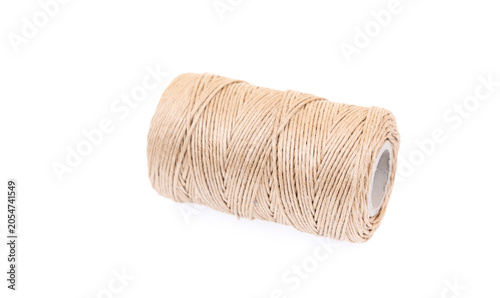 Natural jute twine spool isolated on white background, close-up of rustic string roll for packaging, crafting, wrapping and handmade projects with minimal design concept.