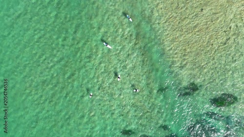 Drone video aerial view of surfers waiting to catch the next wave at a beach in Sydney Australia in summer 