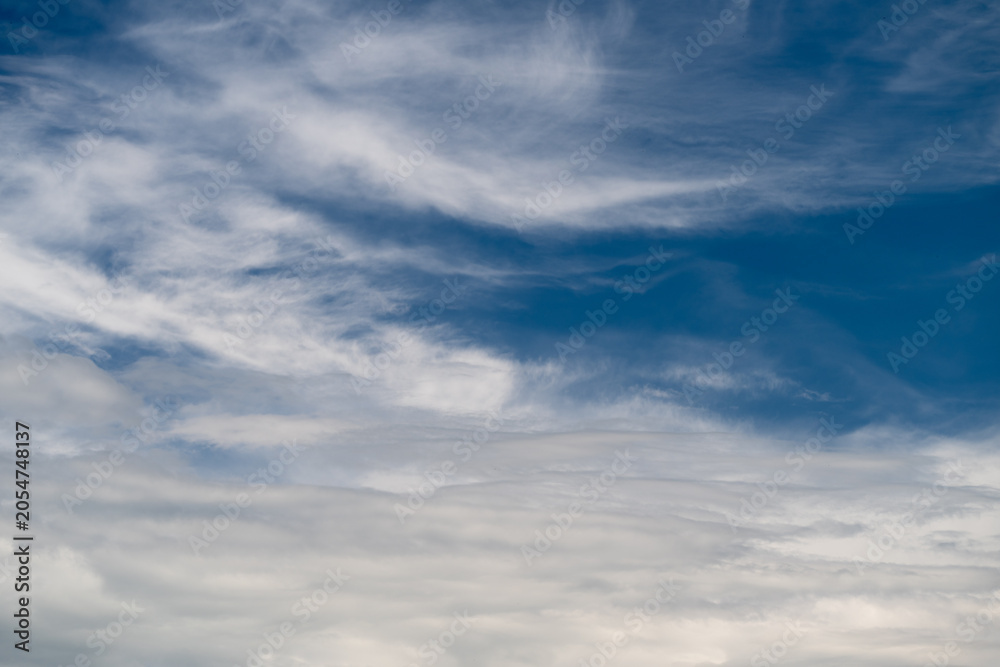 Obraz premium Peaceful sky vista. Quiet sky with gentle clouds. Serene atmosphere under multilayered cloud canopy. Calm and tranquil celestial scene with soft sunlight and distant horizons
