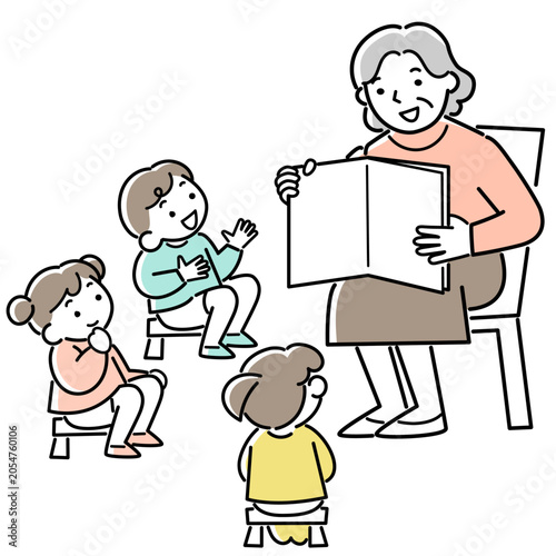 子供たちに読み聞かせをするシニア女性