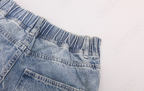 Loose fit light blue women's jeans with elastic waistband, light blue background