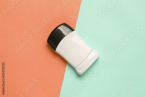 Antiperspirant tube on pink blue background. Sweat protection. Top view
