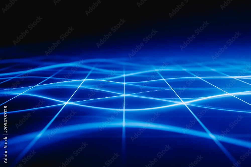 Obraz premium Abstract glowing blue light grid forming a dynamic digital network, representing modern technology and data connectivity.