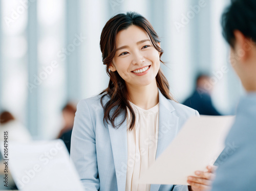 Businesswoman Holding Documents in Office Meeting