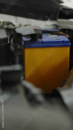 Car battery with yellow case and blue cover