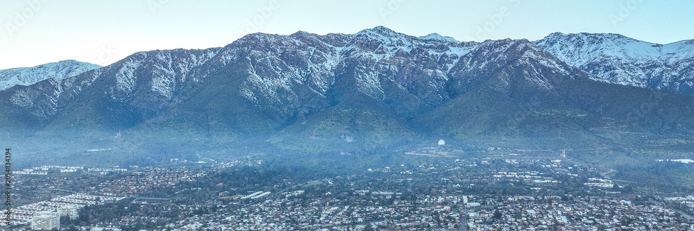 Fototapeta premium Santiago, Chile. Aerial view with the Andes mountain range in the background. Mountain range and snow-capped mountains.