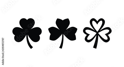 Tableau sur toile Three black clover silhouettes against a white background showcasing distinct le