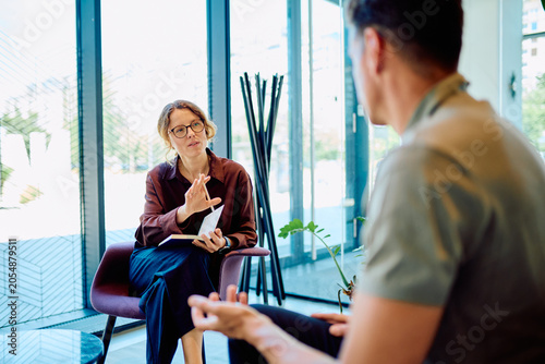 Bild auf Leinwand Female professional giving guidance and support to a man during a therapy sessio