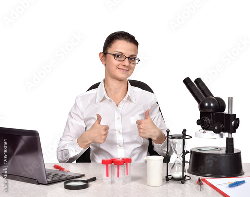 Female scientist showing thumbs up in laboratory
