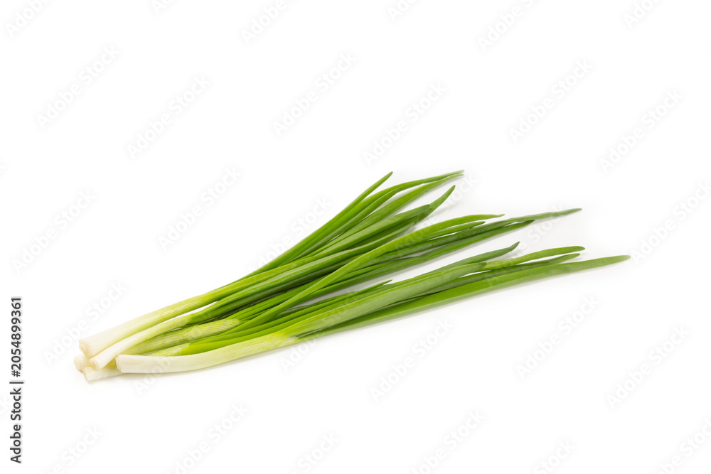 Fototapeta premium Green onions isolated on white background. Sliced ​​green onions in a bowl on the table. Fresh herbs on a cutting board. Organic natural greens. Vegan. Space for text. Copy space.