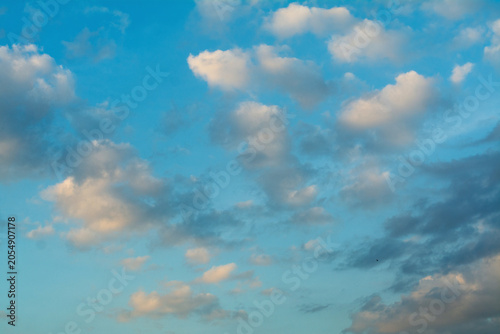 The sky, clouds, changing weather in the blue sky, plumes of smoke gathering into abstract clouds.