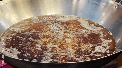 The oil is boiling in the hot pan.