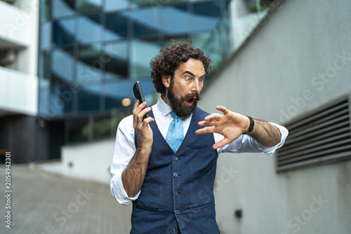 Obraz na plátně Stressed businessman looking at watch experiencing time pressure
