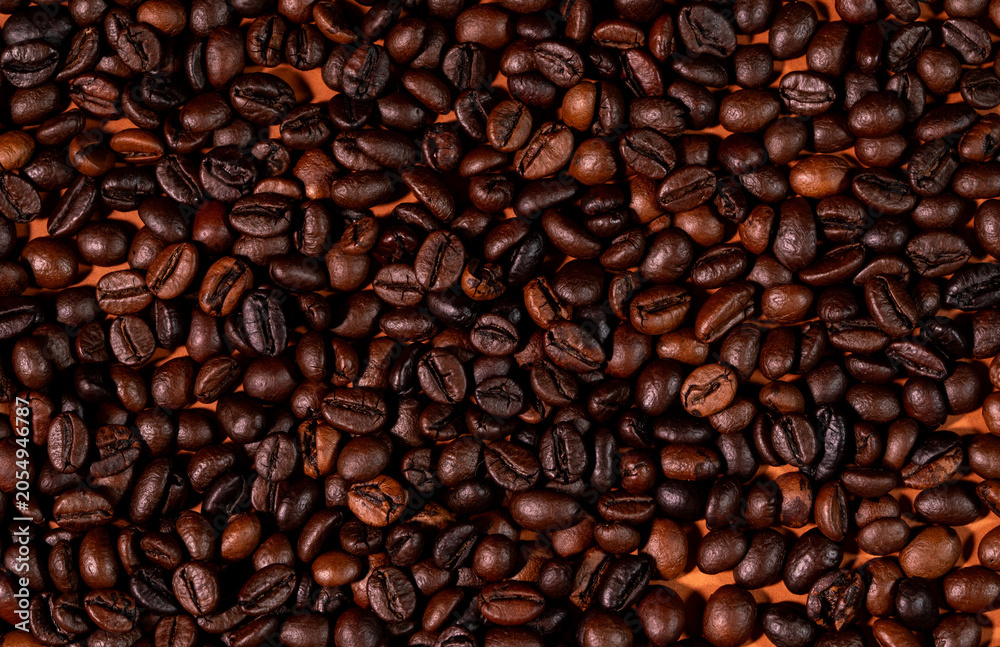 Fototapeta premium Close-up macro shot of roasted coffee beans with dark background. Fresh aromatic coffee beans with rich texture and warm tones, perfect for café, beverage.