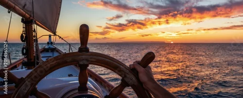 Panel kuchenny z motywem Hand steers sailboat on calm ocean waves at vibrant sunset. Ship sails towards distant island on horizon. Nautical journey begins under dramatic sky.