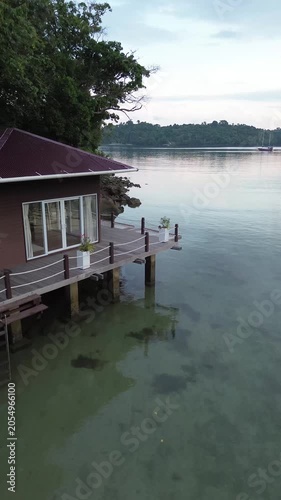 Aerial view of Tropical beach resort with overwater bungalow. Luxury overwater villas on blue lagoon, white sandy beach in Weh island, Sabang Aceh, Indonesia