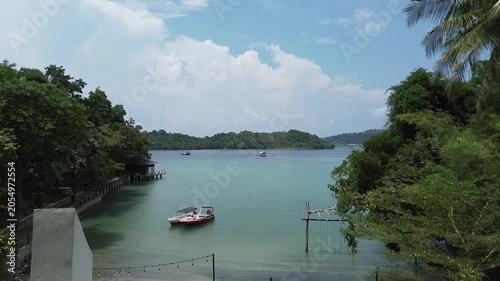 Aerial view of beautiful beach in Sabang Island in Aceh, Indonesia. Drone reveal shot of a beach from resort and beach villa. Summer vacations concept in tropical resort