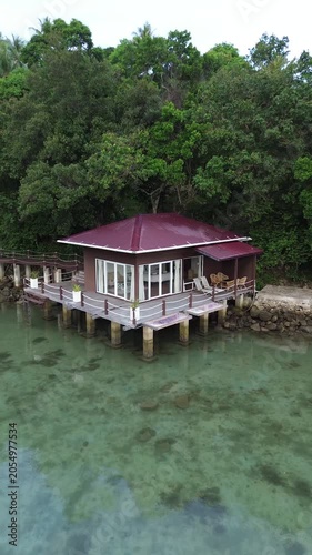 Aerial view of Tropical beach resort with overwater bungalow. Luxury overwater villas on blue lagoon, white sandy beach in Weh island, Sabang Aceh, Indonesia