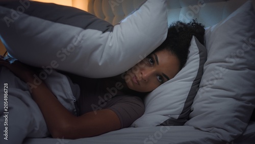 Bild auf Leinwand Irritated African American woman suffering with noisy neighbours problem trying