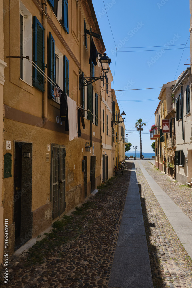 Fototapeta premium A cobbled street in the centre of Alghero, Sardinia, Italy