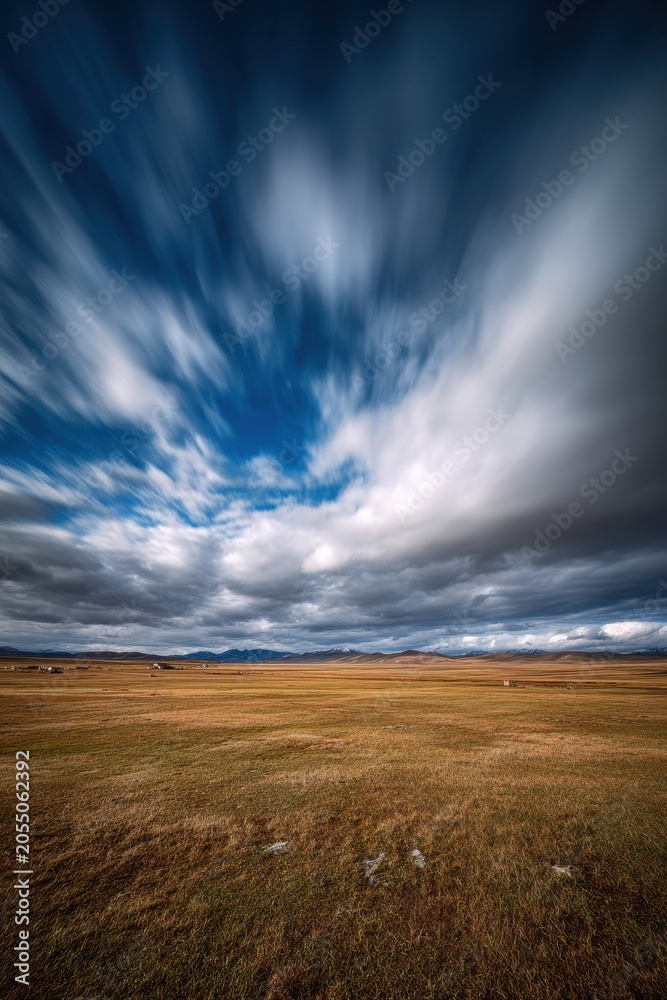 Fototapeta premium Vast grassland landscape on the Tibetan plateau under dramatic clouds