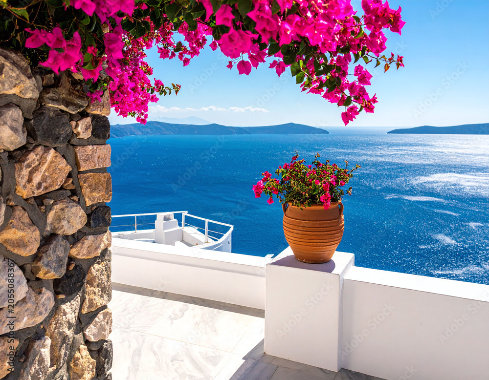 Naklejka premium Admire stunning Mediterranean views with vibrant pink bougainvillea framing a deep blue sea, perfect for luxury travel promotions, vacation concepts, and romantic getaways.