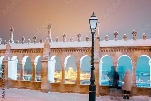 Hungarian Parliament building framed by Fisherman's Bastion arches in winter, Budapest