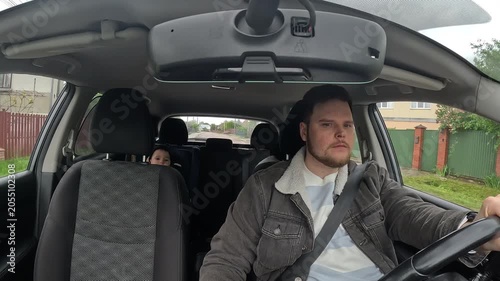 Father Driving Car With Son and Mother in back seats