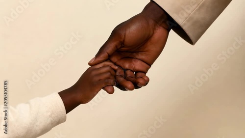 Adult and child holding hands in a warm and loving connection