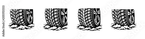 Set of four black and white tire treads digging into snow or dirt