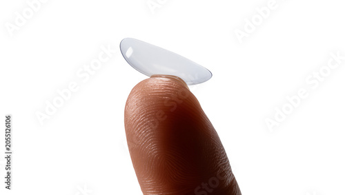 фотографія Isolated transparent contact lens resting on a person's fingertip, ready for eye