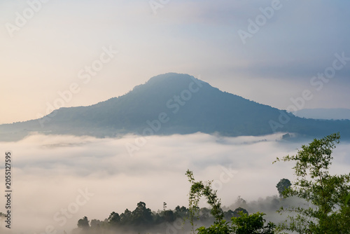 Misty Mountain Sunrise: A majestic mountain peak emerges from a sea of soft, ethereal mist as the first light of dawn paints the sky with gentle hues, creating a serene and breathtaking vista.