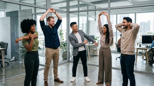 Diverse multiethnic office team doing stretching exercises during work break. Healthy happy multicultural colleagues practicing corporate wellness and active lifestyle in modern workspace.