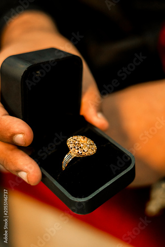 Close up of gold engagement ring in a black velvet box with engagement proposal precious accessory marriage ceremony