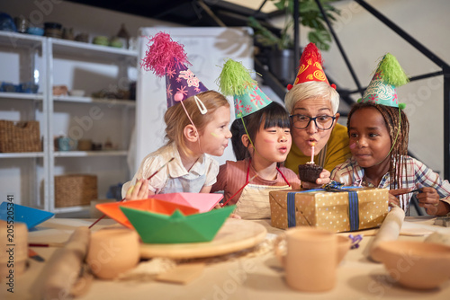Children celebrating birthday together on pottery workshop