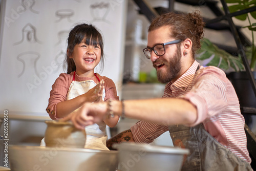happy Creative chinese girl on pottery workshop.  Creative  hobby  workshop  concept