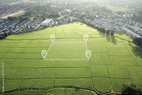Land with surveyed parcel boundary and digital location markers. Real estate concept representing land plot for sale, land surveying, cadastral mapping, property boundaries, parcel identification.