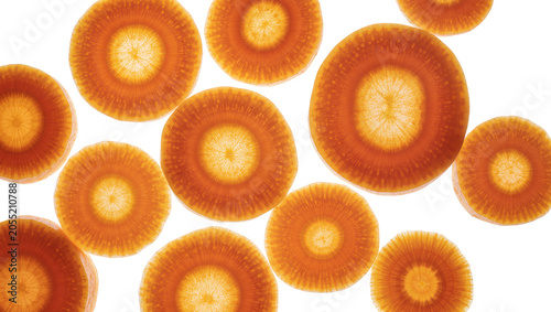 Konstfotografi Isolated vibrant orange carrot slices backlit, highlighting their detailed natural structure