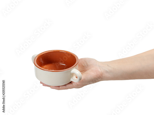 Cooking bowl on the woman's palm with the white background.