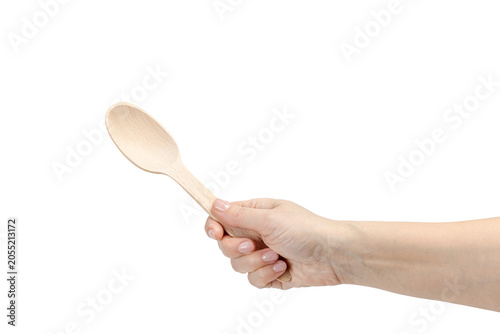 Woman's hand holding a wooden spoon on the white background.
