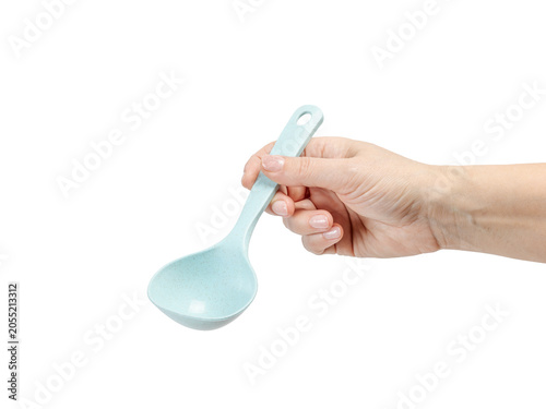 Woman's hand holding a spoon on the white background.