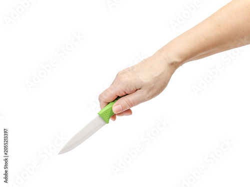 Woman's hand holding a kitchen knife on the white background.