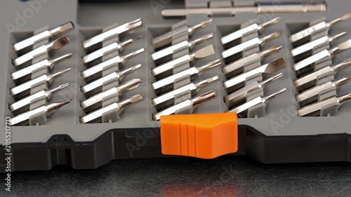 A set of metal bits for installation work in a plastic case.