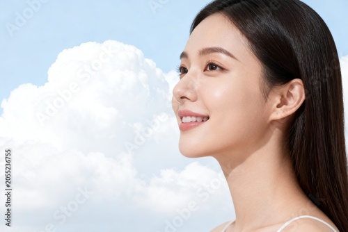 Woman with glowing skin against a blue sky