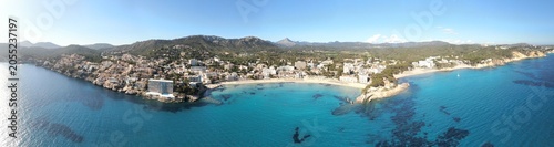 Panoramic Mallorca beach view of Paguera coast, with blue crystal clear water and fine sand. Concept of relaxation and summer holiday in a resort.