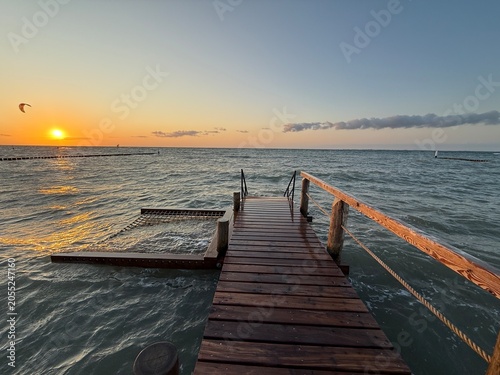 comfortable hammock on a wooden pier over the sea in sunset