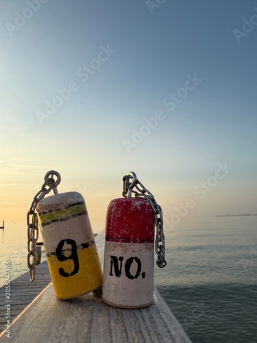 small handmade buoys as decoration on the beach by the sea