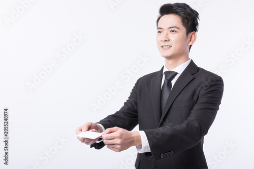 Obraz na plátně Smiling young businessman handing over a blank business card