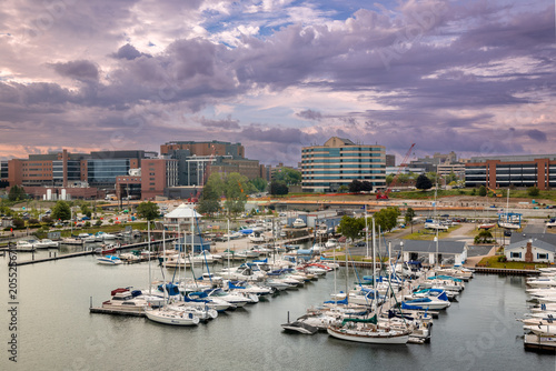Erie Pennsylvania downtown skyline, Boats docked in a marina with modern buildings and cloudy sky overhead