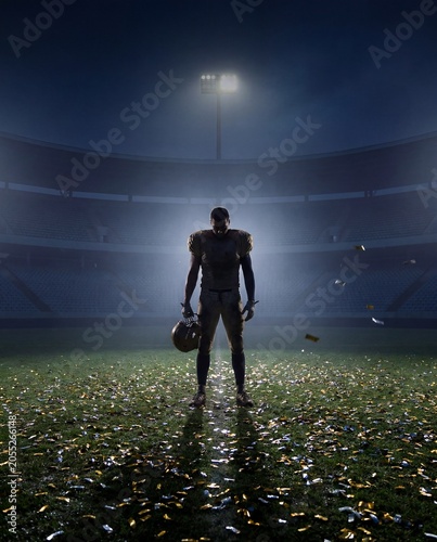 American football player standing alone on empty field after emotional night game. Concept of post-game defeat, career pressure, lonely setback, comeback mindset and sports resilience.